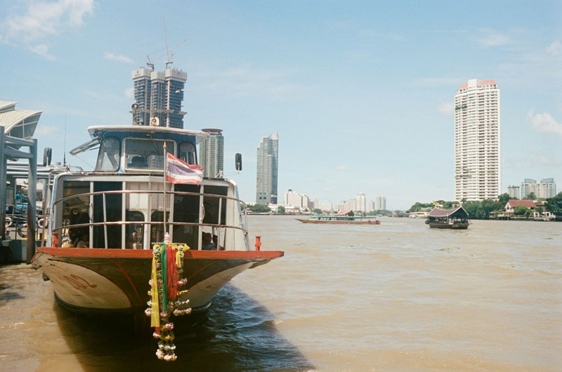 A boat on the Chao Phraya River in Bangkok waits to take mourners to scatter the ashes at sea.