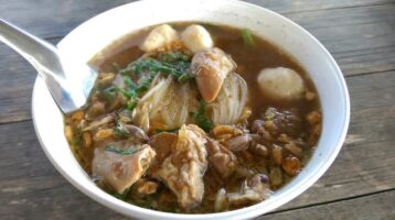A bowl of hot cooked Thai noodle soup