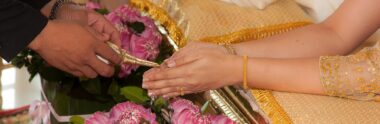 Thai wedding water pouring ceremony over the hands of the bride and groom