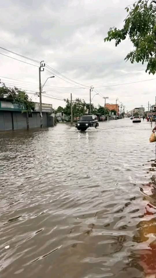 Car driving through a flooded suburban road in Bangkok
