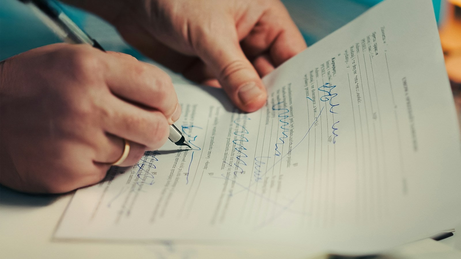 A person signing a property contract with a pen