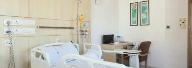 Private hospital room with an adjustable bed and visitor chair