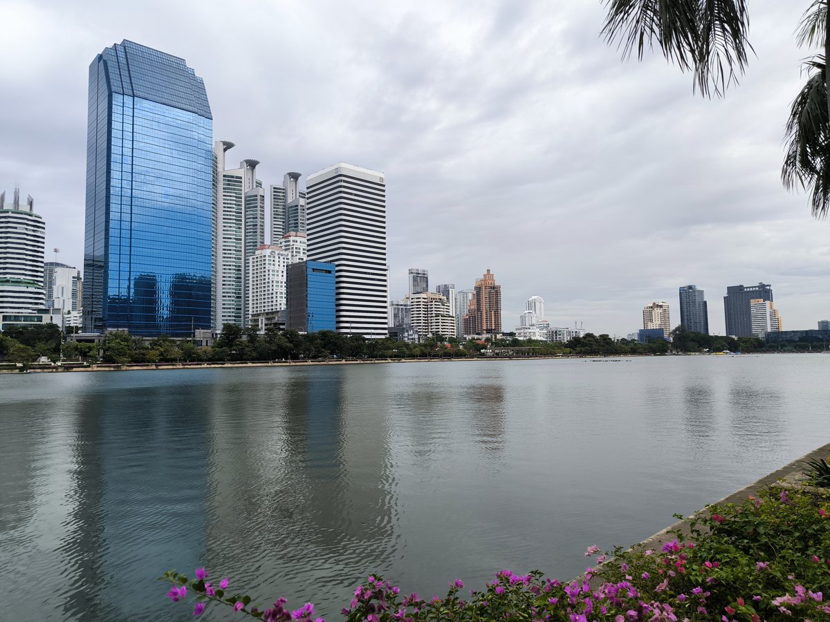 Benjakitti Park lake in Bangkok with the Asok and Sukhumvit skyline behind it