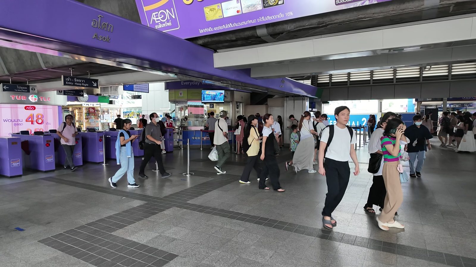 Commuters walking through BTS Asok station