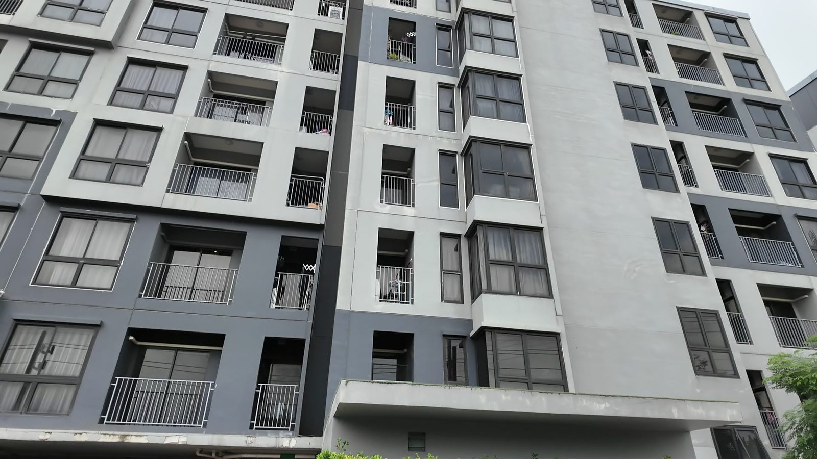 A mid-rise condo building with balconies in Ekkamai, Bangkok