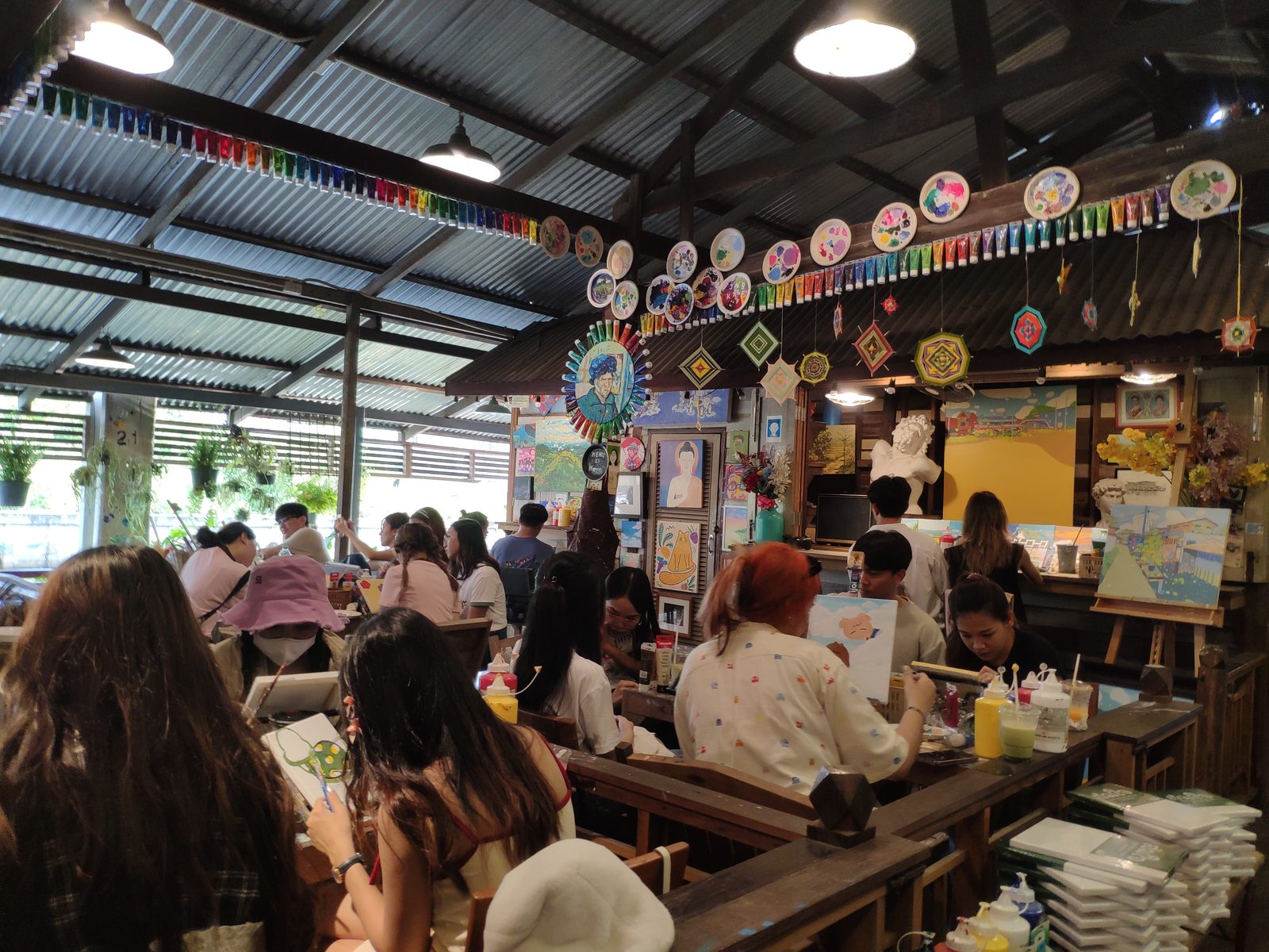 A busy cafe with painted walls at Hua Takhe market in Lat Krabang
