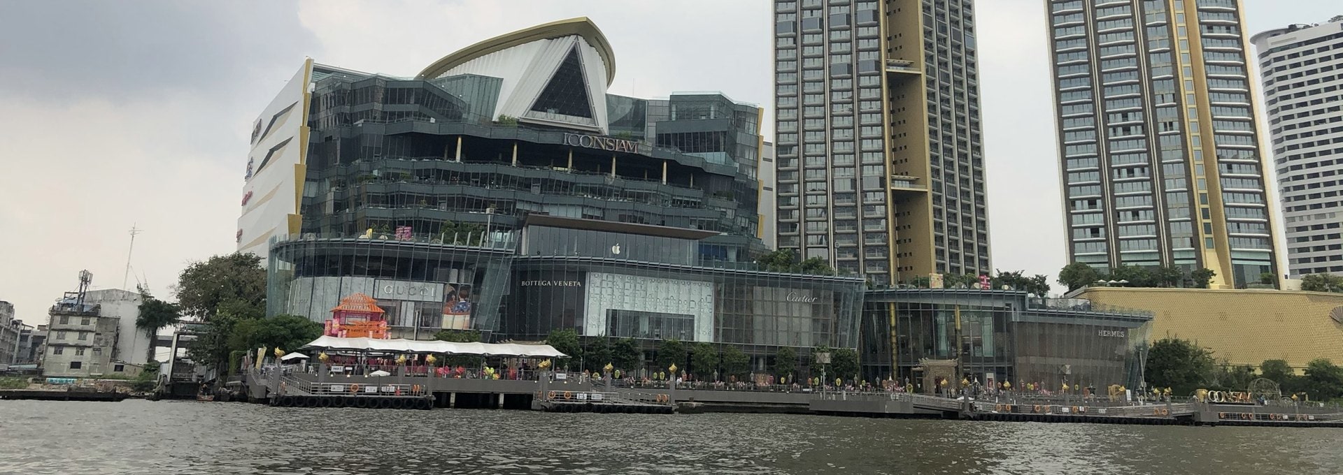 Iconsiam mall and the Magnolias towers seen from the Chao Phraya River in Khlong San, Bangkok