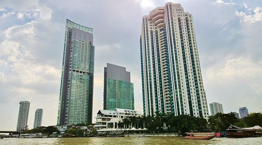 Riverside condo towers and The Peninsula Bangkok on the Khlong San bank of the Chao Phraya