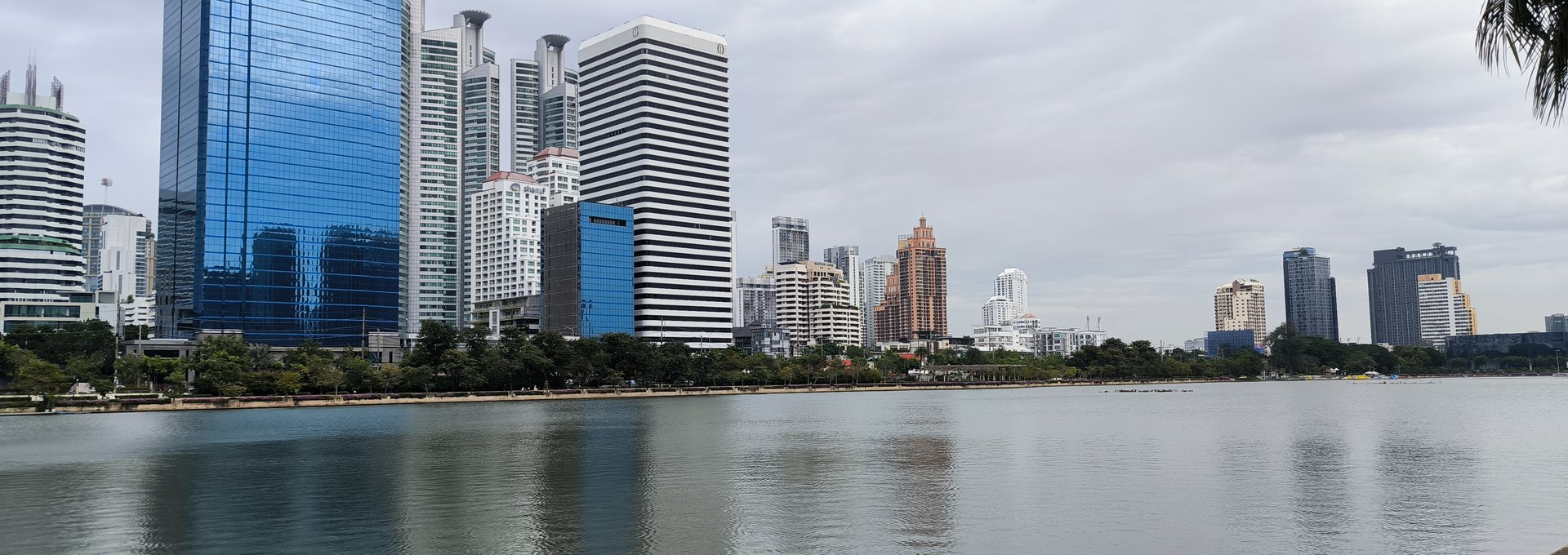 Benjakitti Park lake in Khlong Toei, Bangkok, with the Sukhumvit skyline behind it