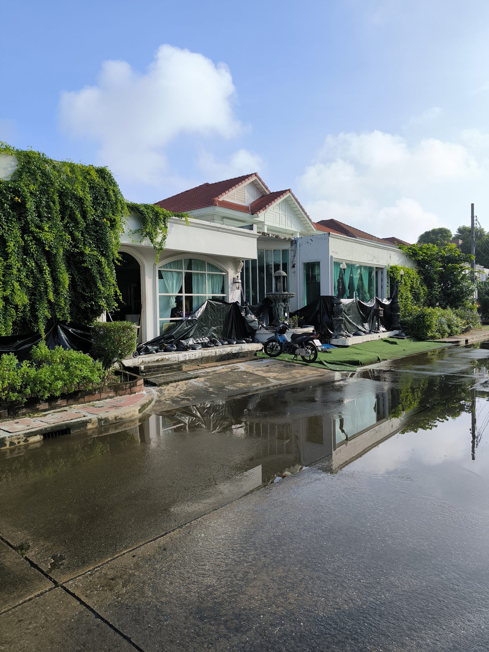 Floodwater on the street outside a detached house in Min Buri