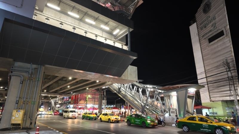 Min Buri Market station on the MRT Pink Line at night, with taxis on Sihaburanukit Road below