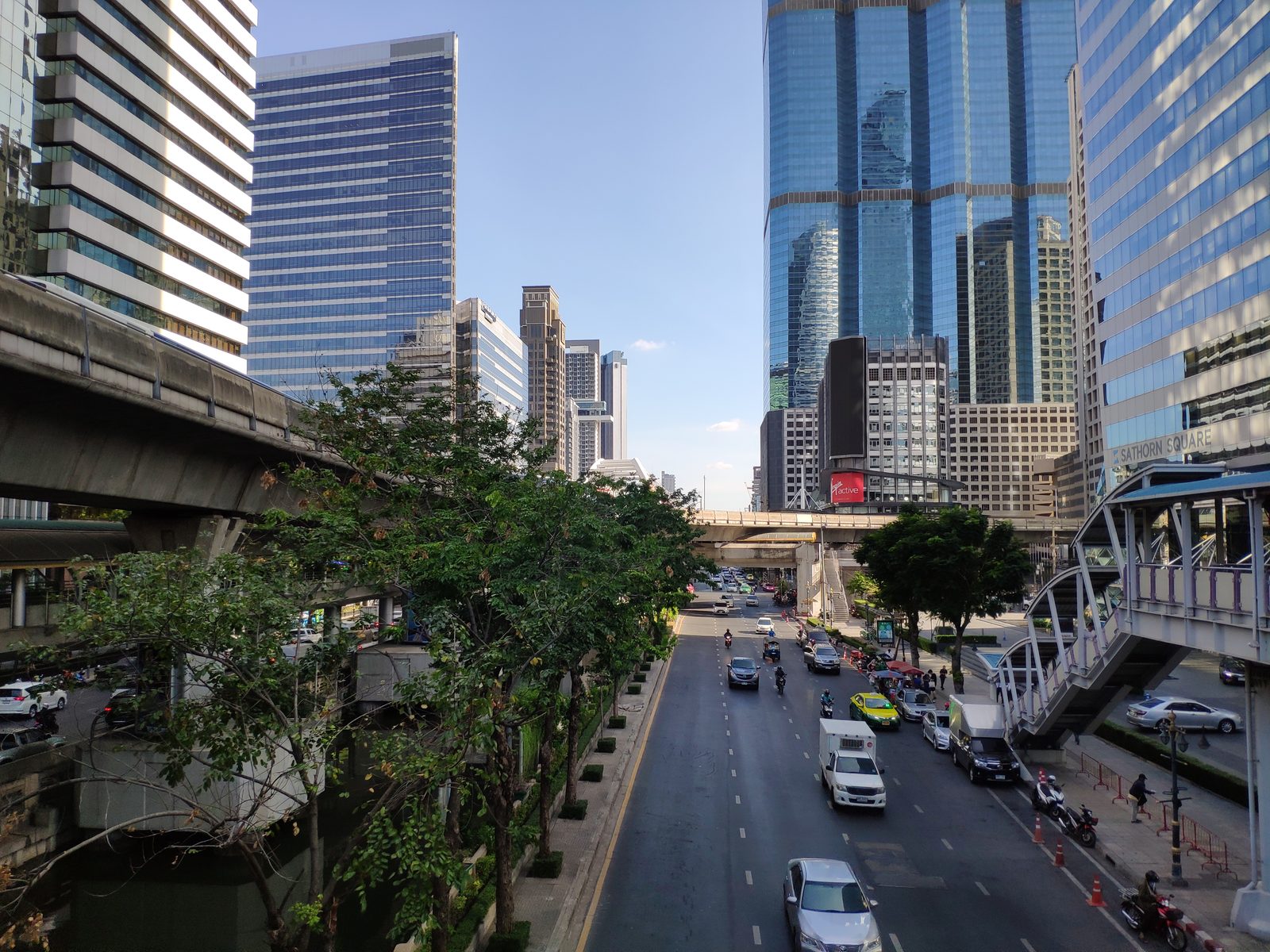 View from the skywalk at BTS Chong Nonsi in Sathorn, Bangkok, with office towers and Sathorn Square