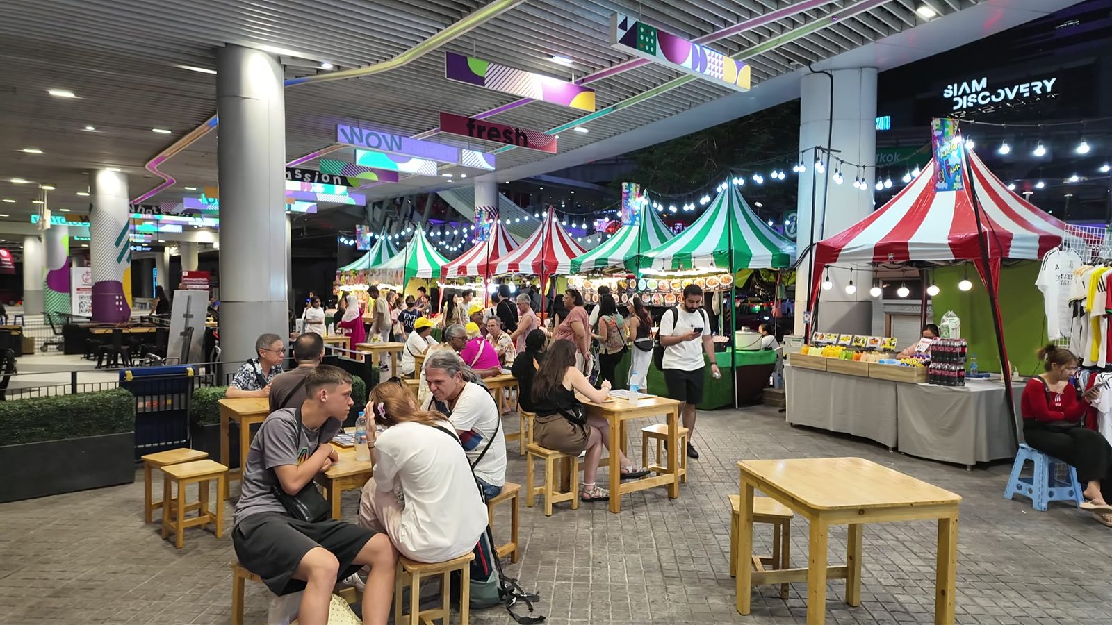 Street food stalls under red and white tents near Siam Square and MBK