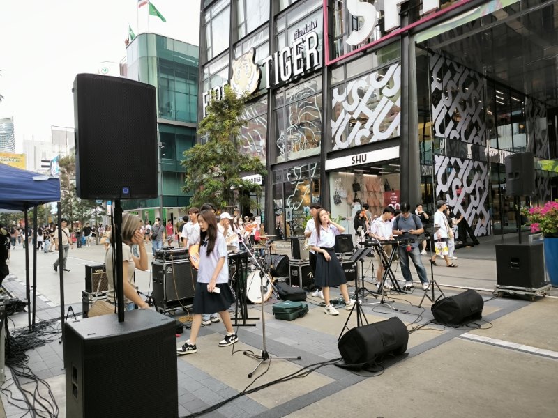 Thai students in school uniform playing a street gig outside the shops in Siam Square, Bangkok