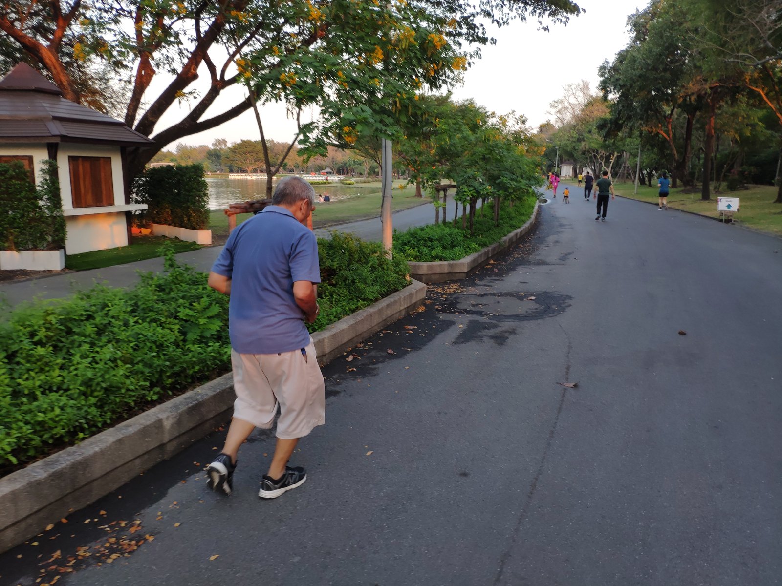 A man walking on the running path in Suan Luang Rama IX park, Bangkok