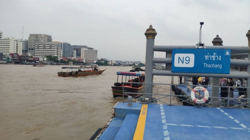 Tha Chang pier N9 on the Chao Phraya River with boats and the Thonburi bank behind